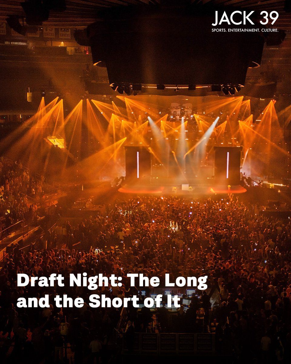 NHL Draft Night This is a view from the back of a crowded arena that is packed full of people before an empty stage with a podium. Vibrant orange lights and smoke fill the room in anticipation for the next draft pick to be announced. On top of the graphic reads the title, "Draft Night: The Long and the Short of It" with the white Jack 39 logo in the upper left corner of the image.