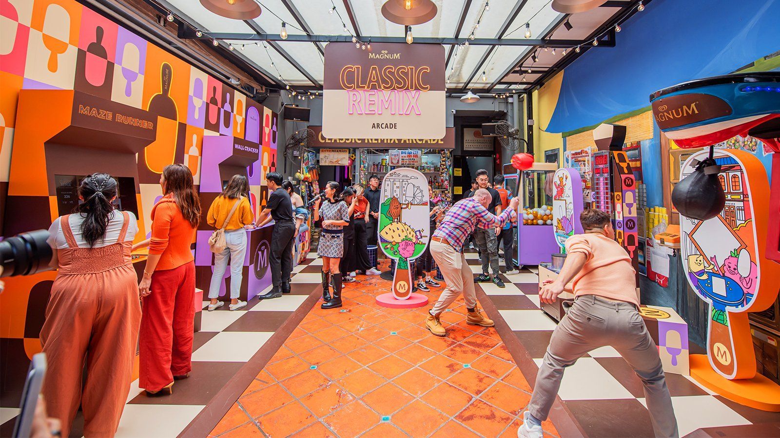 A vibrantly colored arcade room is full of people interacting with the different games that are all Magnum branded. Prominently above the experience is a large neon sign that reads, “Classic Remix.”